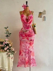 A vacation-style tie-dye floral maxi dress with a draped halter neck, featuring sheer mesh and metal buckle details. Ideal for beach getaways, tropical trips and summer parties.