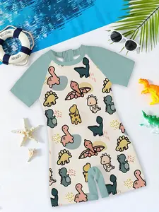 Boys' One-Piece Swimsuit "Morandi Cute Dinosaur Style" Morandi colors with full prints of Q-version cartoon dinosaurs + bean green raglan short sleeves design, soft, cute, and sun-protective, creating a full summer pool/beach water-play atmosphere