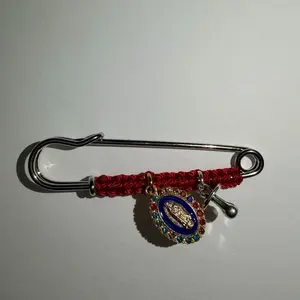 Pregnancy protection pin with the Virgin of Guadalupe charm and a pacifier charm