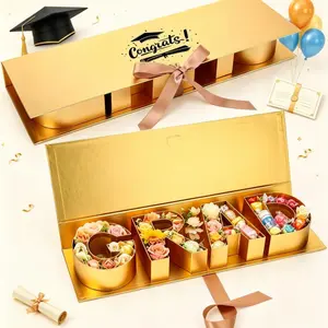 2026 Graduation Gift Box 16.5 Inch, Gold and Black Grad Letter Shaped Fillable Cardboard Box with Greeting Card & Raffia Grass, Glitter Blue Rose Decor DIY Grad Tray Box for High School College Graduate Party Favors Gifts