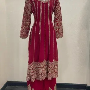 This elegant outfit is a 3-piece embroidered free size For 38 to 44 party wear suit, typically featuring a long kameez (top), matching pants or a sharara/palazzo, and a dupatta (scarf). Womenswear
