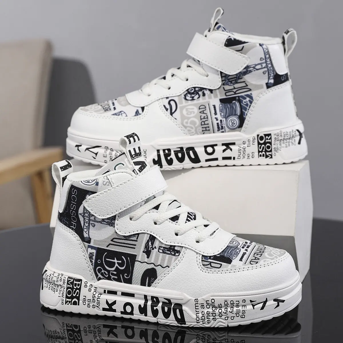 Kids’ trendy graffiti letter sneakers—soft cushioning that absorbs impact so kids don’t get tired when running and jumping; Velcro closure, no laces; unisex casual shoes for children.