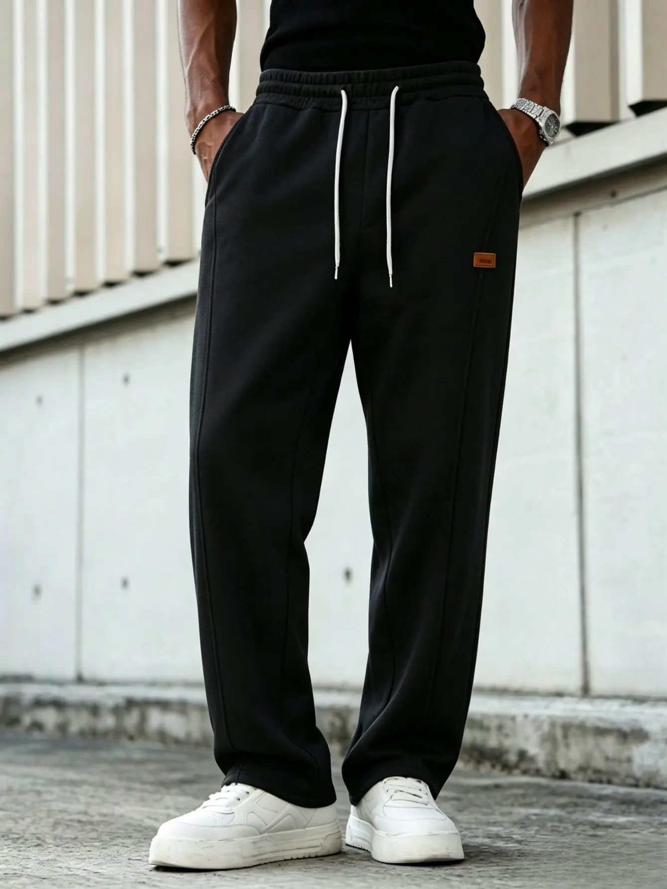 Men’s drapey straight-leg casual sweatpants with elastic drawstring waist, leather logo detail, solid color, loose wide-leg athletic pants—versatile for everyday wear and workouts