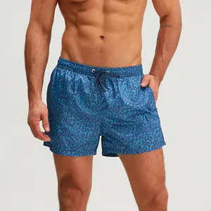 Men's teal athletic shorts with drawstring closure featuring an elastic waistband, lightweight quick-dry fabric, and allover leopard print in a trendy vacation style suitable for the beach or poolside lounging
