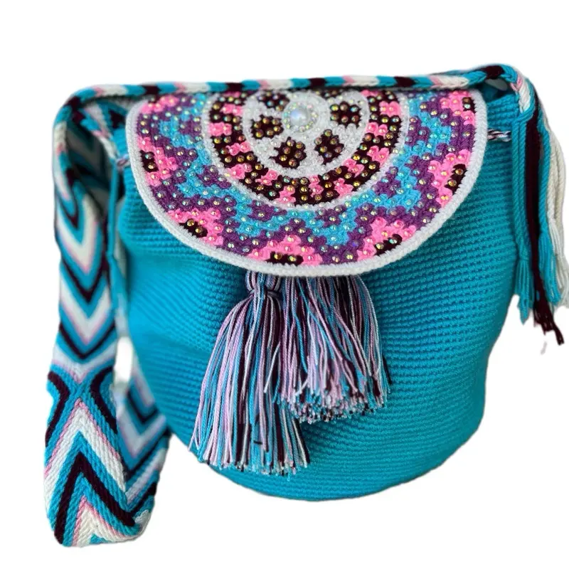 Handwoven wayuu medium size bucket bag. Handmade with two threads in crochet technique. Beaded design on round lid. War crossbody o shoulder strap.