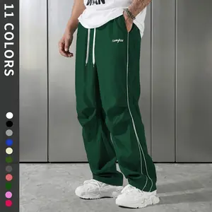 Men’s athletic casual pants—American striped quick-dry loose high-street parachute pants. Quick-drying, loose high-street style, suitable for everyday wear and outdoor activities; all-in-one athletic casual design.