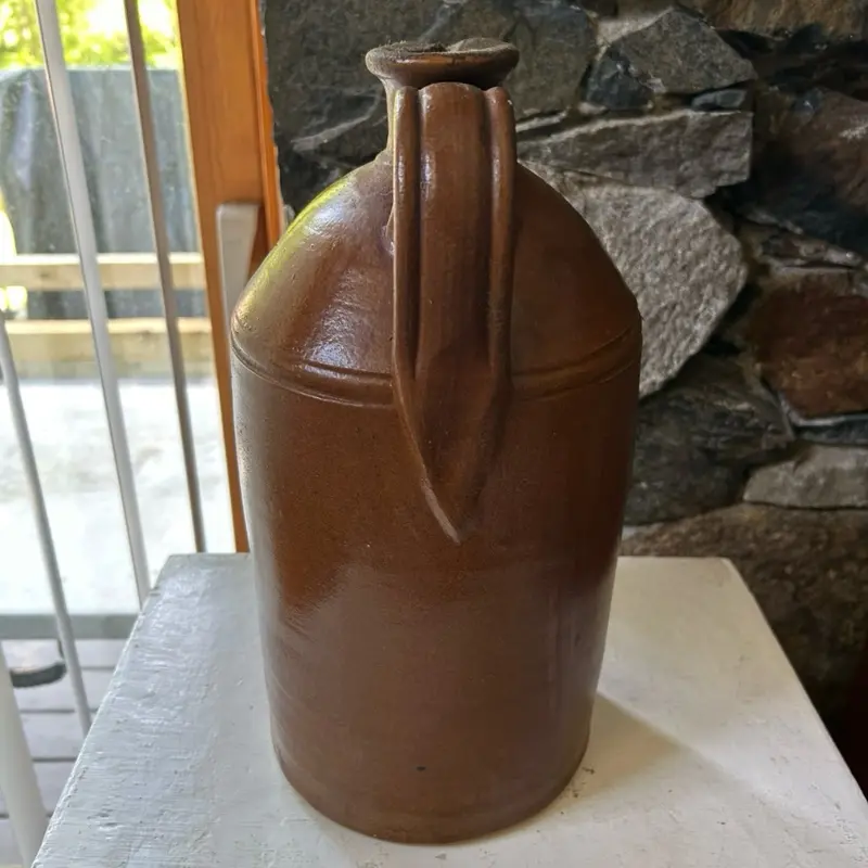 Vintage brown salt glaze stoneware jug used for honey or spirits