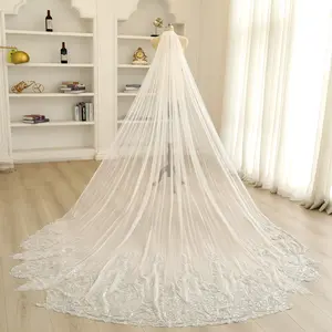 Elegant beaded and sequined irregular-edged silver hair comb with a long, sheer bridal veil.