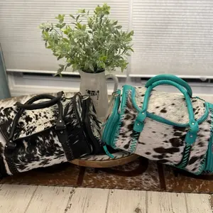Cowhide Duffel Bag with Turquoise Accents and Sleek Black Top Handle