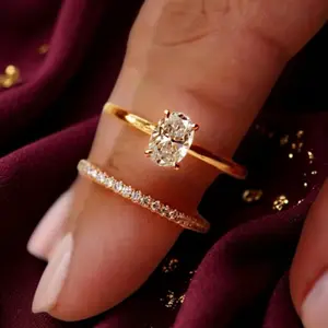 Set of 2 14k gold-plated rings with Cubic Zirconia stones, suitable for engagement/wedding/promise. These oval-shaped, sparkling rings are exquisite pieces of jewelry, perfect as gifts or for parties