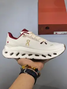 Obsessed with this clean white running sneaker with red and gold accents, cloud-like cushioning for workouts and everyday style