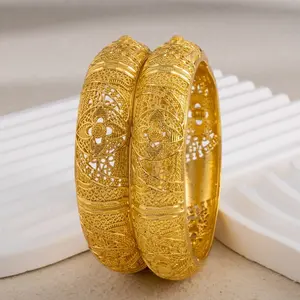 Wide gold bracelet with hollowed-out gold leaf design, featuring traditional clasp design