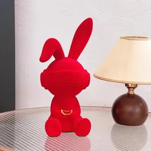 A modern decorative rabbit ornament in red—simple yet stylish—perfect for Christmas decor. It blends seamlessly into contemporary home settings and is suitable for display on bookshelves, coffee tables, entryways, or as part of your holiday decorations.