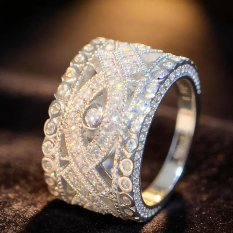 A wide ring surrounded by multiple dazzling synthetic , featuring a European vintage luxury style, with exquisite hollowed-out inlay details that fully showcase elegance, making it a perfect gift for your girlfriend, bestie, or mother