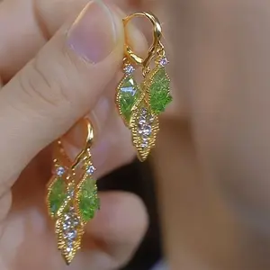 Pair of Elegant Golden-Tone Leaf Dangle Earrings with Sparkling Green Rhinestones and Clear Gemstones, Stainless Steel Posts, Perfect for Parties or Casual Attire, Party Accessories | Sparkling Earrings | Rhinestone Embellishments, Novelty Earrings