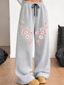 A pair of women's casual trousers with an American-style retro vintage elegant aesthetic design, featuring a fun gothic dark and sweet-cool vibe, and a unique Japanese-style cherry blossom multi-patterned wide-leg straight-leg loose pants