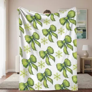 Festive Bows Flannel Throw Blanket Elegant Green Ribbon and Snowflake Print Ultra Soft Warm and Cozy Perfect for Home Decor Holiday Season Snuggles Ideal Christmas Gift Living Room and Bedroom.