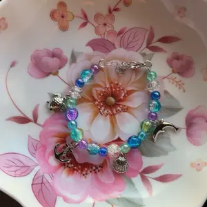 Handmade Ocean Themed Beaded Bracelet with Ocean Charms Glass and Acrylic Beads Adjustable Customizable Featuring Dolphin and Anchor Charms