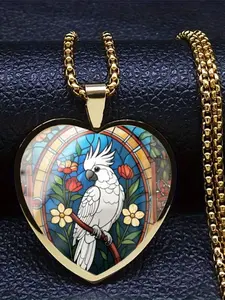 A transparent glass heart-shaped necklace adorned with a delicate bird pattern.