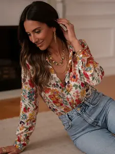 A long-sleeve shirt with a colorful floral print and a collared neckline, belonging to the casual romantic style of shirts. It has a fresh style with a touch of vintage, suitable for everyday outings and light commuting, Blouses
