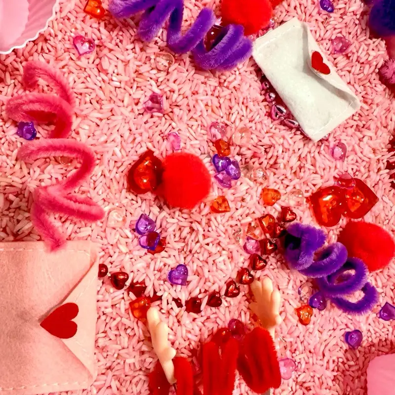 Valentine’s Day Themed Sensory Bin with Assorted Craft Supplies, Colorful Elements, and Heart-Shaped Features