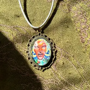 Portrait Pendant Necklace with Intricate Filigree Frame and Vibrant Artwork