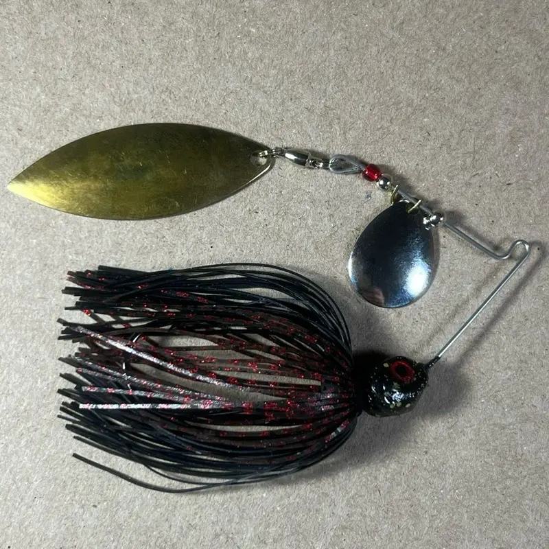 029 Custom Bingo Spinnerbait, 1/2oz Black Neon & Dark Melon Red Tandem Colorado/Willow Nickel/Gold Blades with 80-Strand Tournament-Grade ProUmbrella Skirt, Brass-Based Premium Components, Hand-Crafted in Texas, USA.