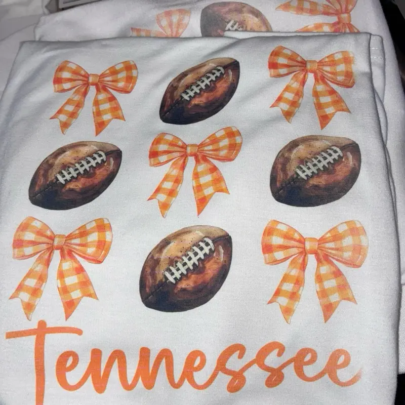 Sublimation VOLS T-shirt with Tennessee Design 100% Polyester Featuring Footballs and Orange Bows