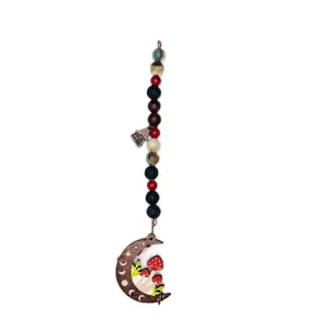 Handmade Aromatherapy Car Charm Hanger with Wooden Mushroom Moon and Copper Cottage charm. This charm hanger features lava stone to add your favorite essential oil for a natural way to make your car or any room smell incredible!