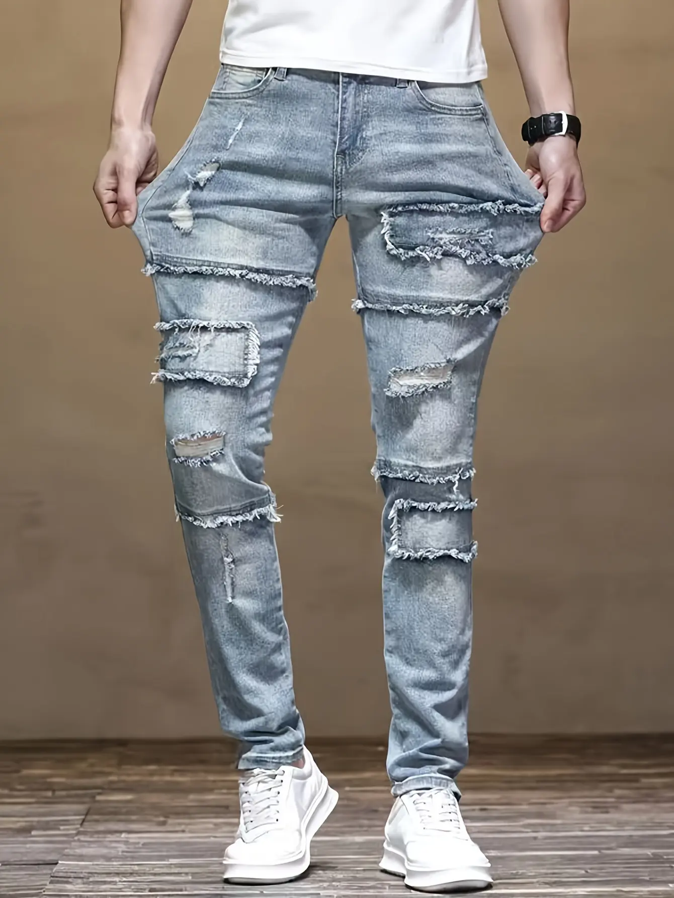 Vintage light blue men’s denim long pants with frayed edges, distressed patches, and a layered design—trendy and distinctive.