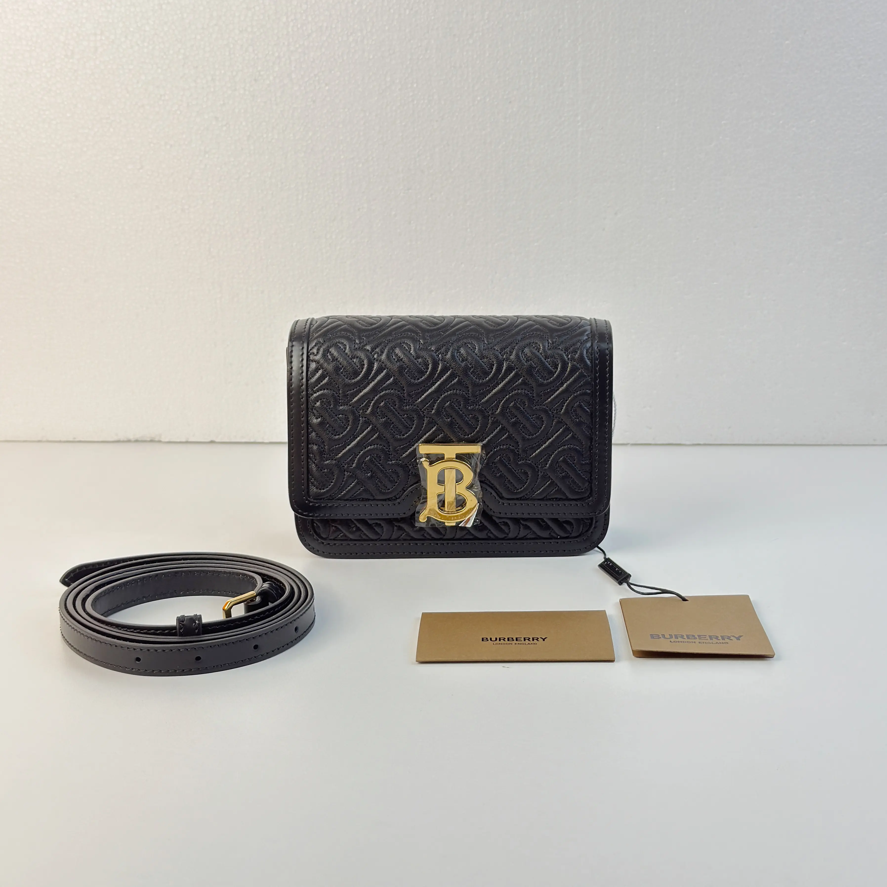 Pre-owned BURBERRY black embossed messenger crossbody bag with gold hardware mssj