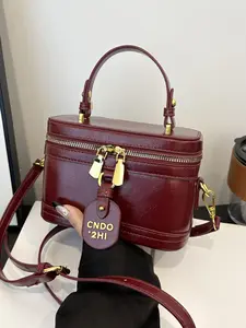 Simple and classic solid color cherry pendant makeup lipstick box bag, metal double zipper can be carried by hand or across the body, small and versatile  suitable for daily travel, shopping, dating, etc.