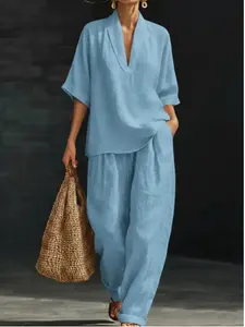 Women’s new minimalist two-piece set with a V-neck: stylish short sleeves paired with wide-leg pants with pockets—ideal for comfortable outdoor walks.