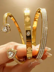 3-piece gold-plated bracelet set, suitable for women to wear. The bracelet is adorned with a heart-shaped decoration, covered with rhinestones, and has a rust-proof feature. Rhinestone Bangle Set