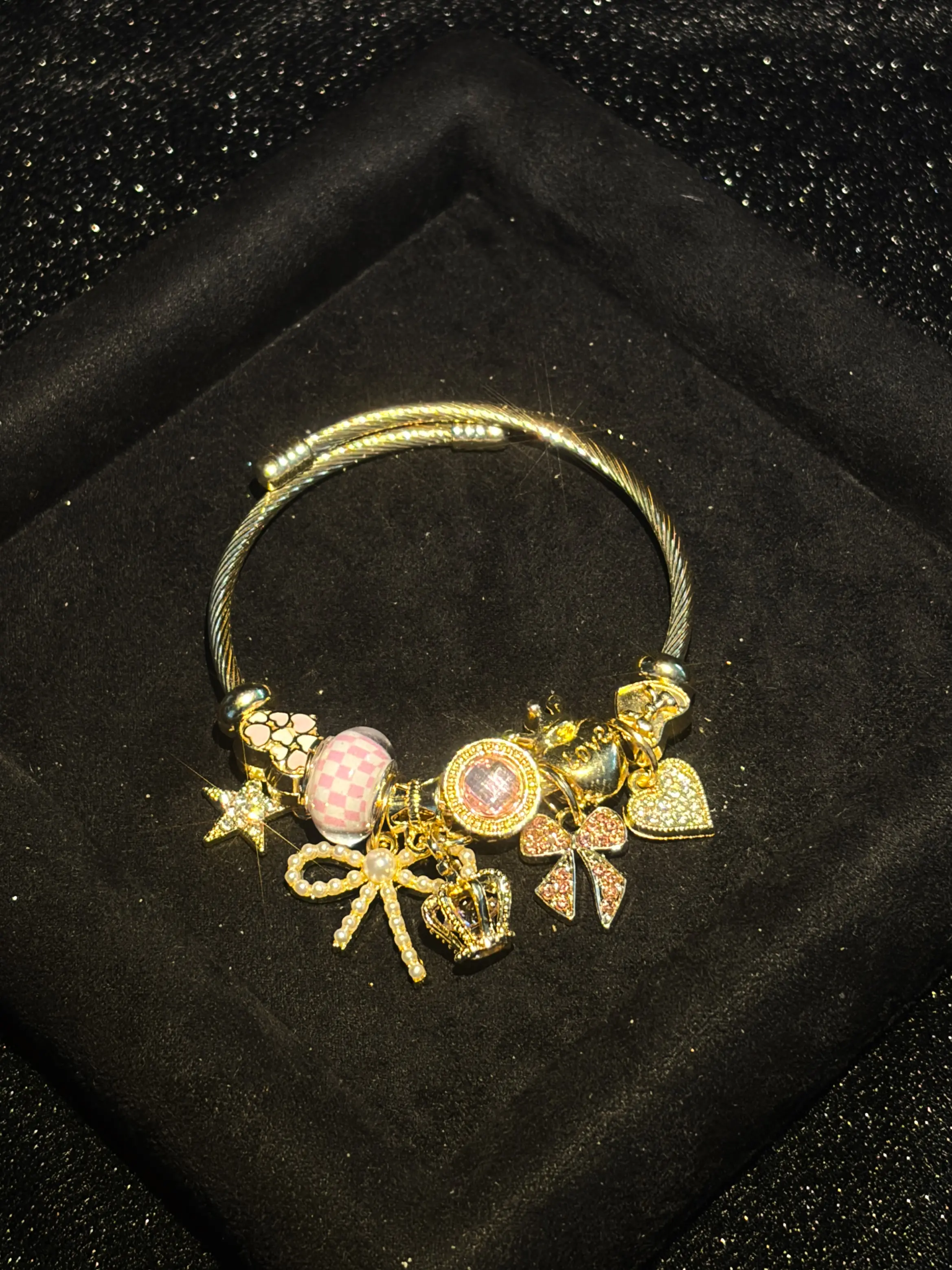 Women's Cute Princess-Style Gold-Tone Adjustable Cable Bangle with Pink Checkered Bead, Bow, Crown, and Heart Dangle Charms