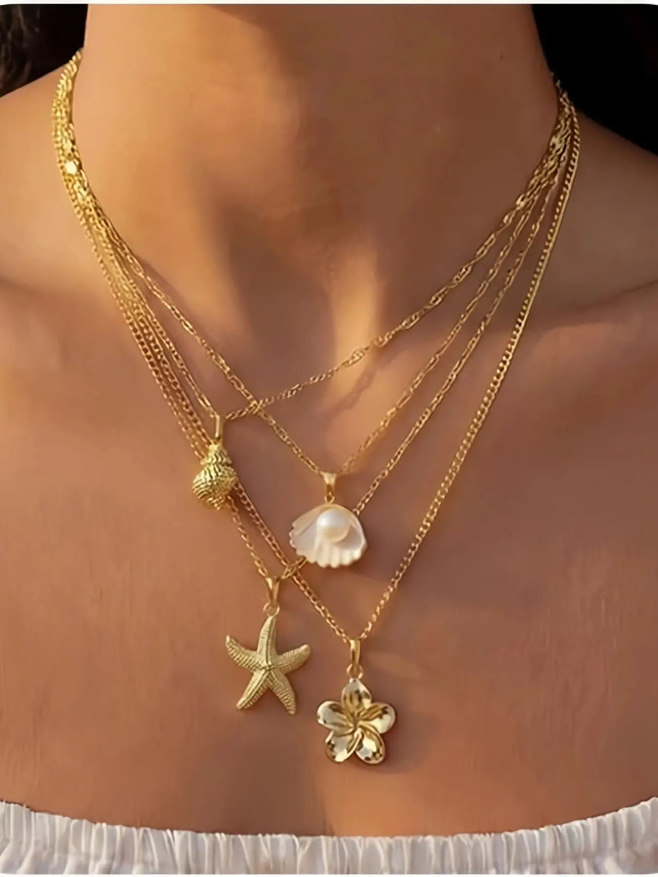 4 Pcs Women's layered necklace featuring shell, starfish, conch, and pearl-shaped pendants, with an adjustable stainless steel chain that is durable and colorfast—perfect for summer beach vacations, Dainty Layering Jewelry