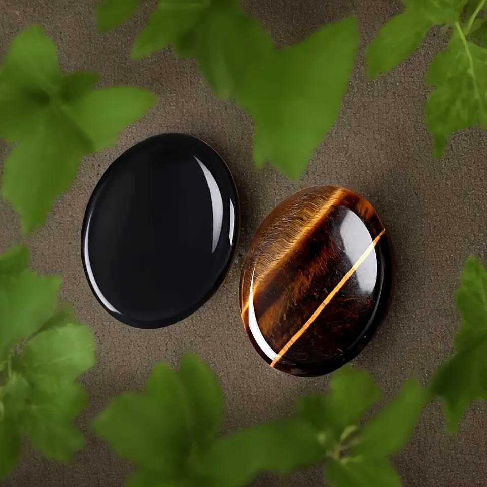 A set of 2 natural stone thumb stones, including tiger's eye and obsidian, oval-shaped pocket stones, perfect for christmas, valentine's day, and thanksgiving gifts
