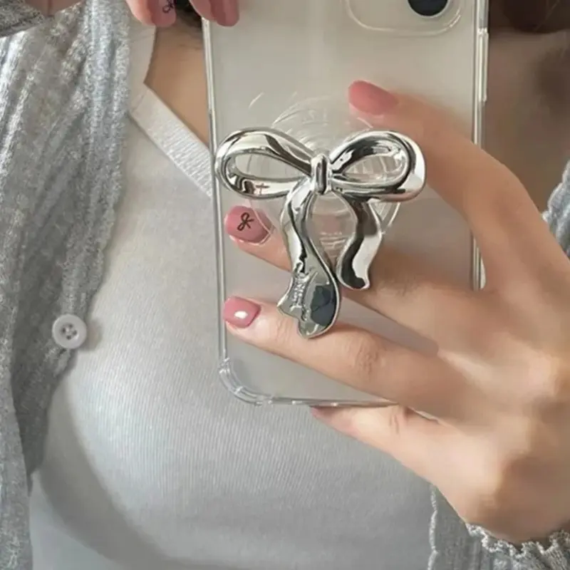 Transparent phone ring holder with Korean silver bow design, suitable for iPhone and Samsung, featuring a foldable base, phone stand, Smartphone Accessories