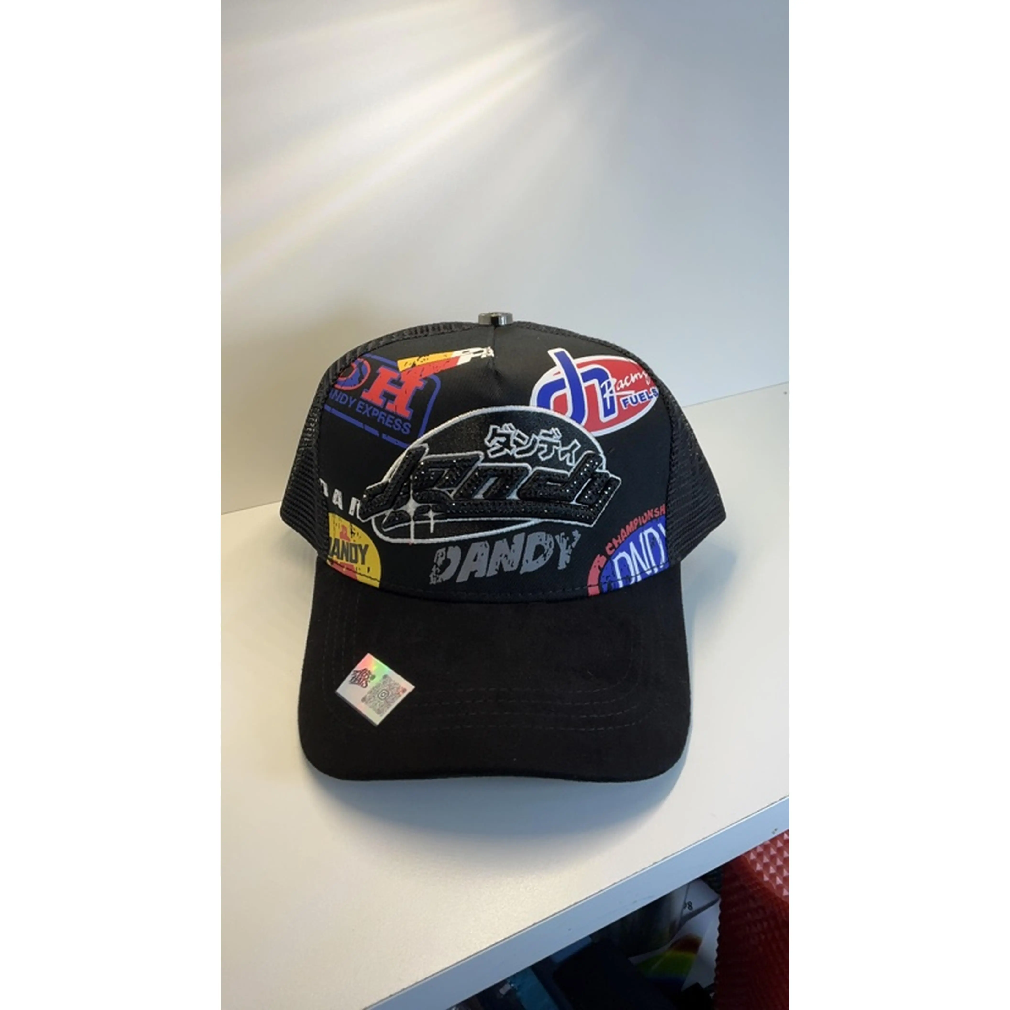 Dandy Hats Anniversary Edition Black Trucker Cap with Colorful Logos and Branding