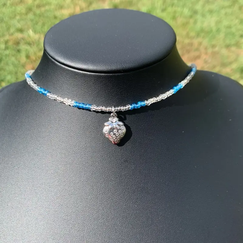 beaded necklace with a strawberry charm