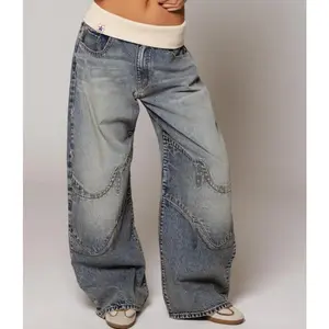 Retro street style, figure-flattering, high-waisted, washed blue denim jeans for women.