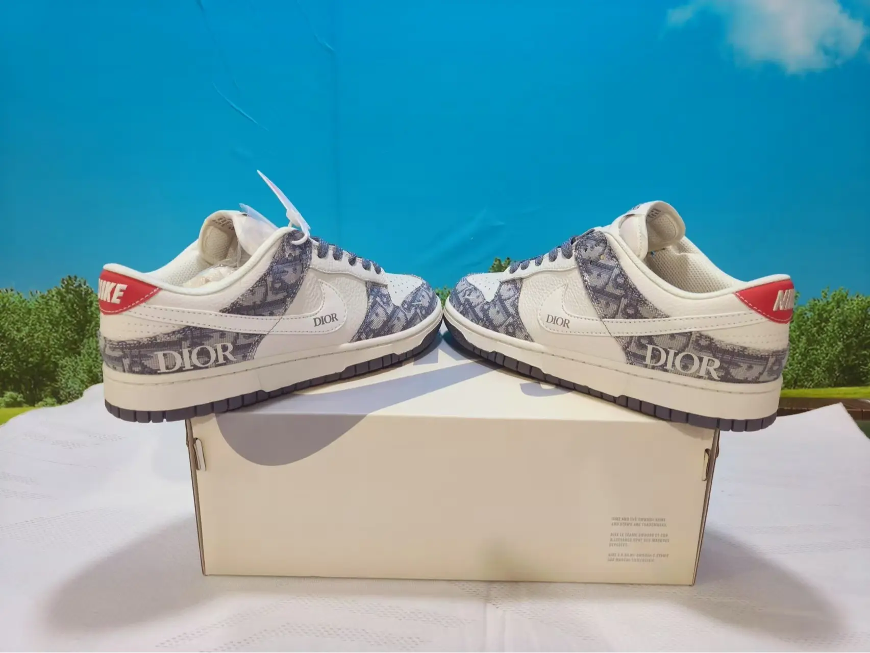 Jacquard leather hybrid retro casual trainers built for versatile calm neutral all-season minimalist vintage street fashion aesthetics, dense creamy off-white smooth leather shell layered with gray woven monogram jacquard overlays and red heel trim