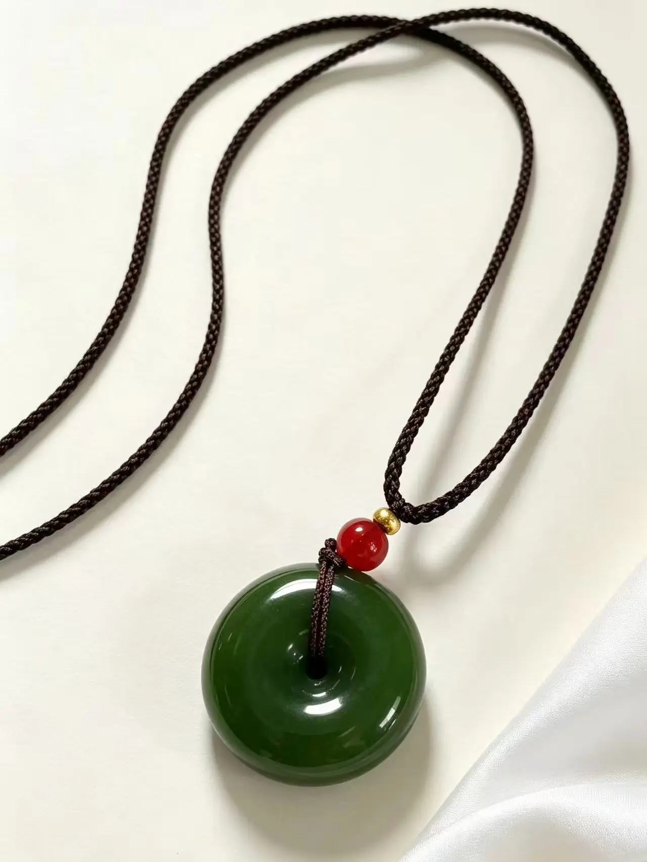E.Ice-clear dark green peace charm — fully polished glossy, minimalist design — understated and versatile for both men and women