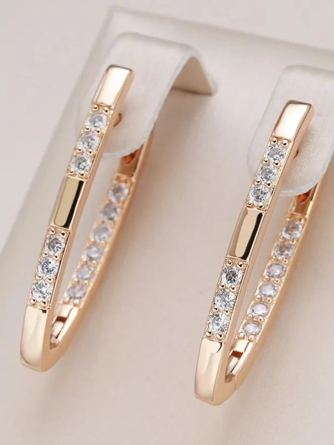 Fashionable, stylish white U-shaped gold-coloured ladies' High Quality Copper Artificial Zirconia Earrings with synthetic zirconia stones. A classic, versatile piece of jewellery for ladies and girls. A perfect gift for parties.