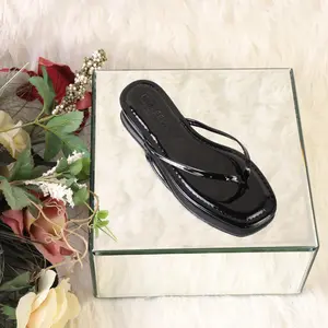 Woman sandal open toe slip in flip flop with a flat heel and square toe