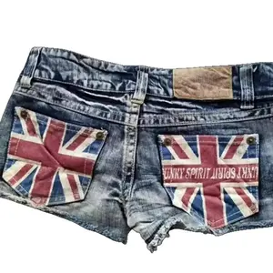 Women’s vintage washed denim shorts with national flag print, punk frayed hem, hot girl streetwear—unique personality short pants GARMENTARY