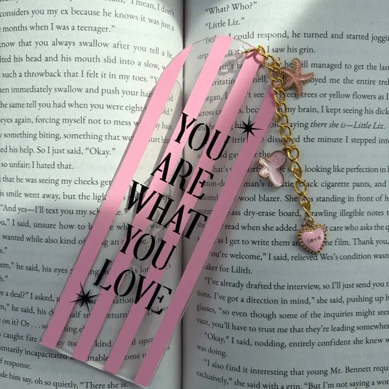 Acrylic Bookmark with Pink Color and "You Are What You Love" Text, Featuring a Heart Charm and Gold Chain
