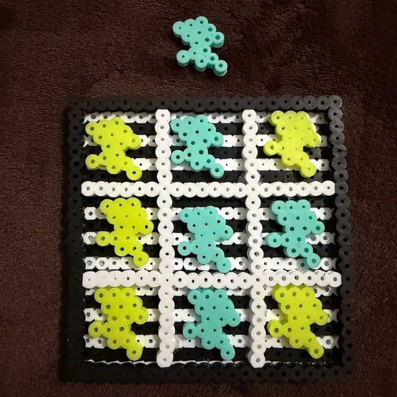 Perler Beaded 10 Piece Tic Tac Toe Board with Lightning Bolt Pieces - Black and White Board, Yellow and Blue Pieces