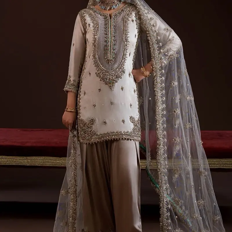 READY TO WEAR    What's Included: Shirt Sleeves Attached Inner Trousers (Elasticized waistband) Dupatta Fabric Details: Shirt: Pure glass silk (kora dabka zardozi work) Sleeves: Same as Shirt  Dupatta: Net Trousers: Pure Chermeuse Silk Disclaimer:  Produc