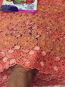 Fehintola Austria Embroidery  Lace Elegant & Luxury Vibe   Luxury Austria Embroidery Lace  A rich coral base adorned with detailed gold floral embroidery — soft, feminine, and undeniably classy.  Perfect for weddings,